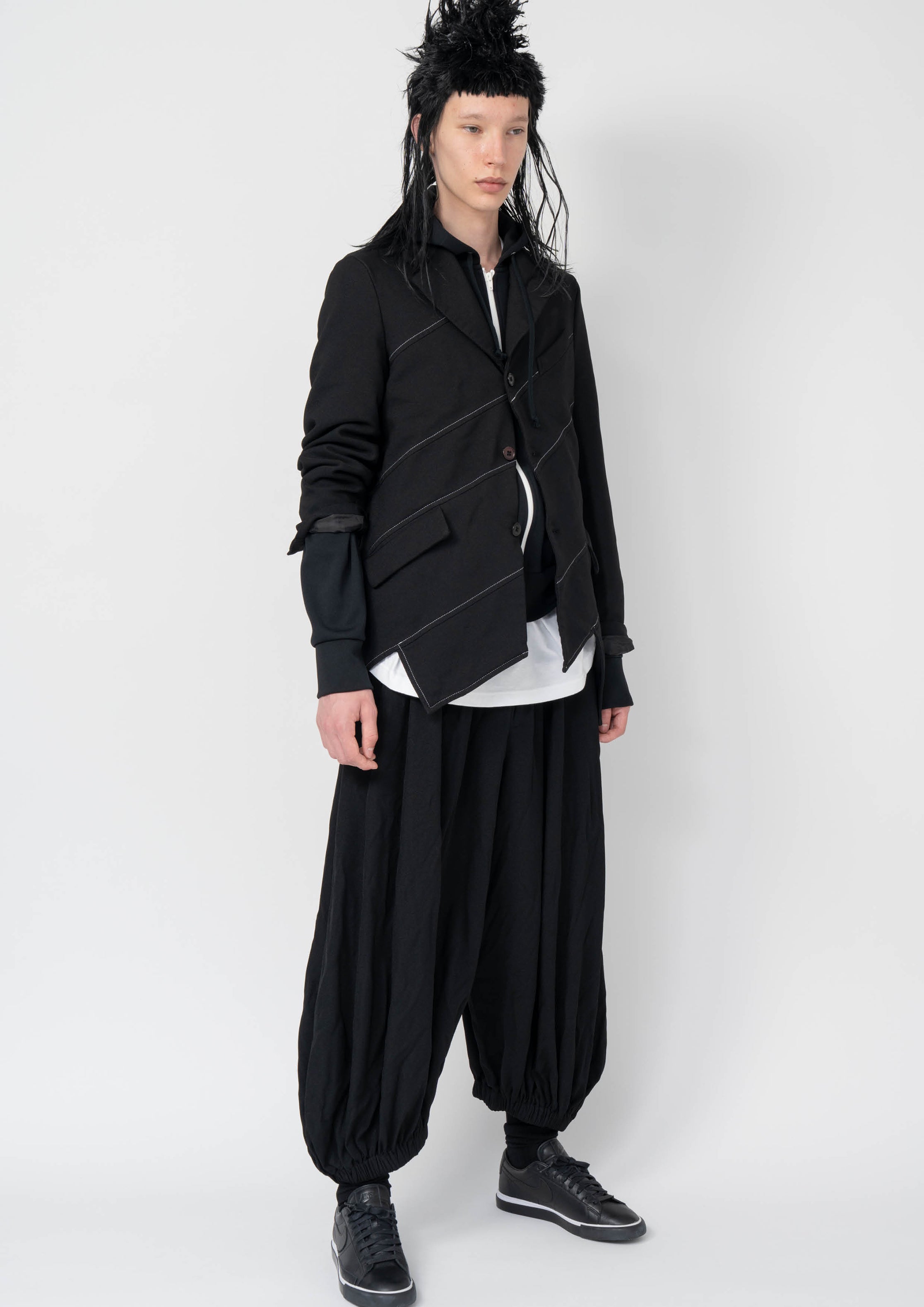 Fashion model wearing a Black Comme des Garçons AW25 outfit