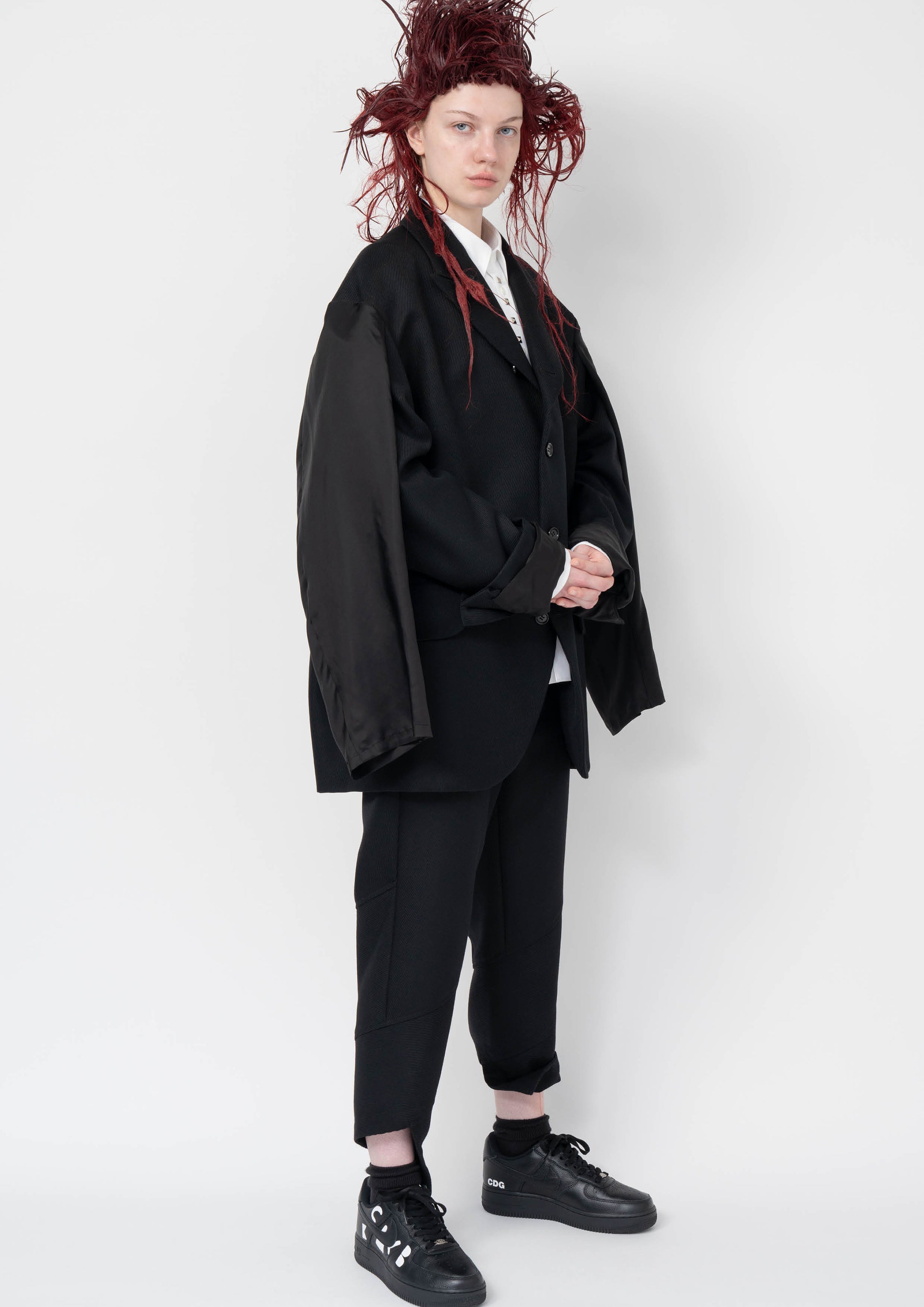 Fashion model wearing a Black Comme des Garçons AW25 outfit