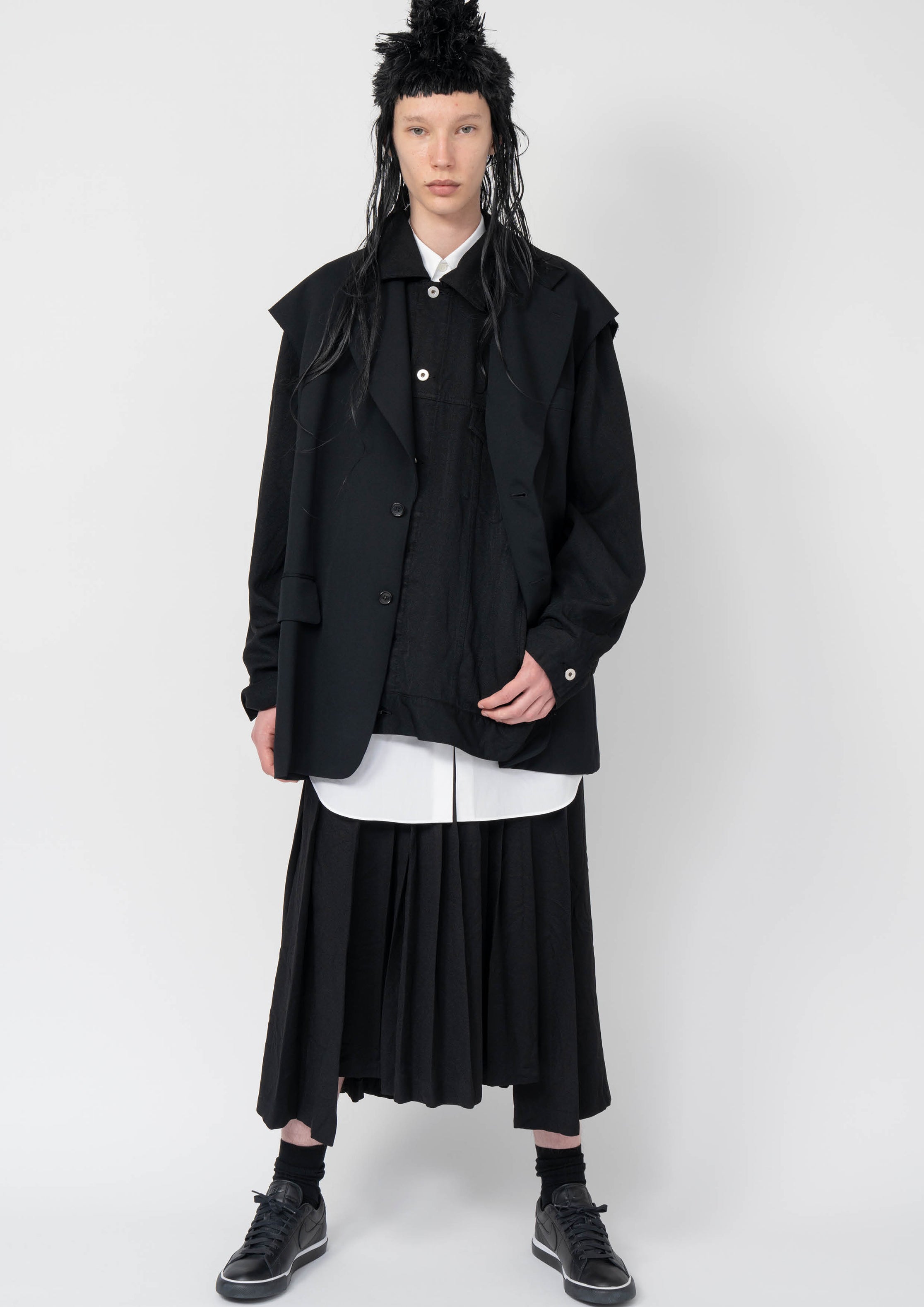 Fashion model wearing a Black Comme des Garçons AW25 outfit