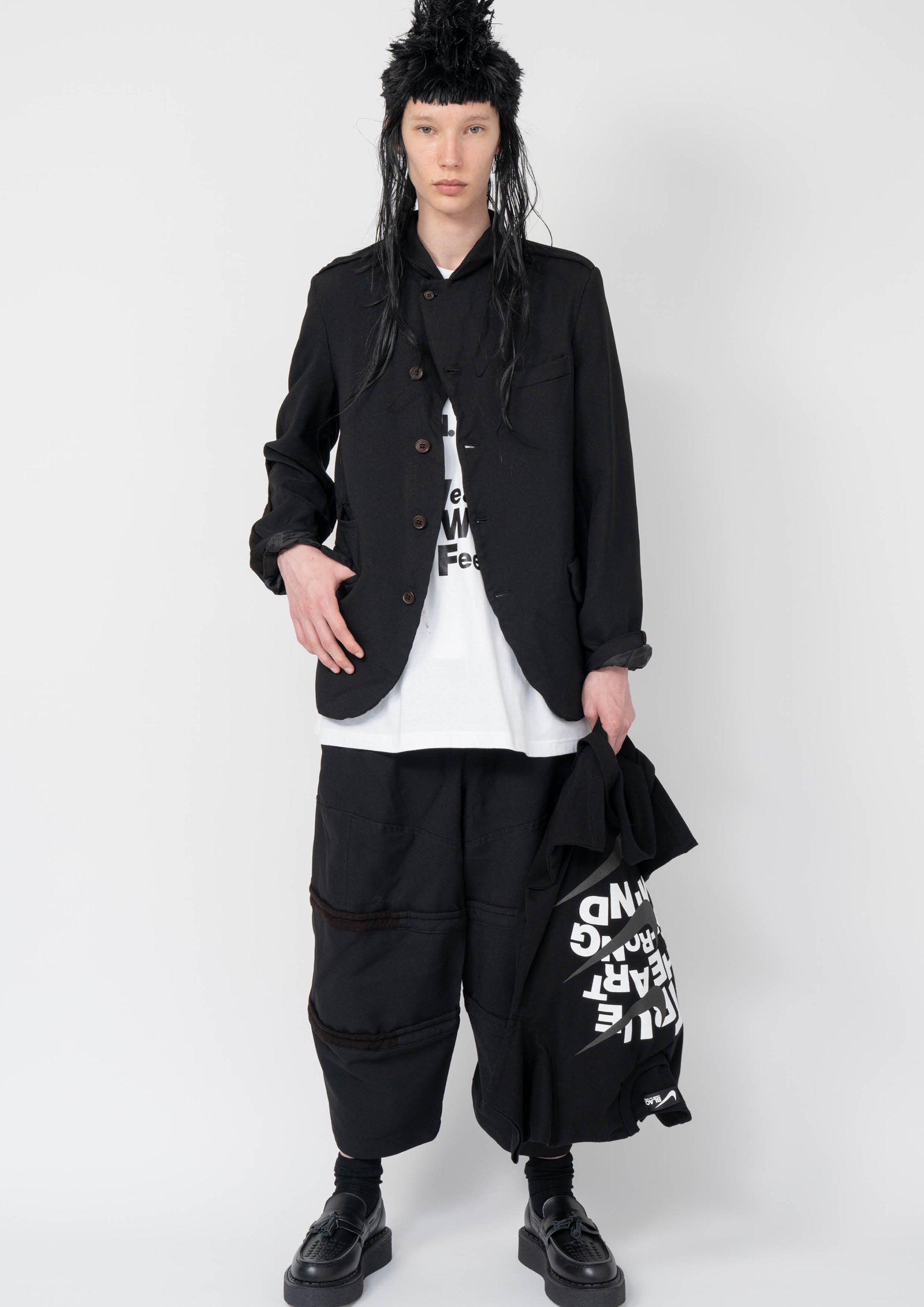 Fashion model wearing a Black Comme des Garçons AW25 outfit