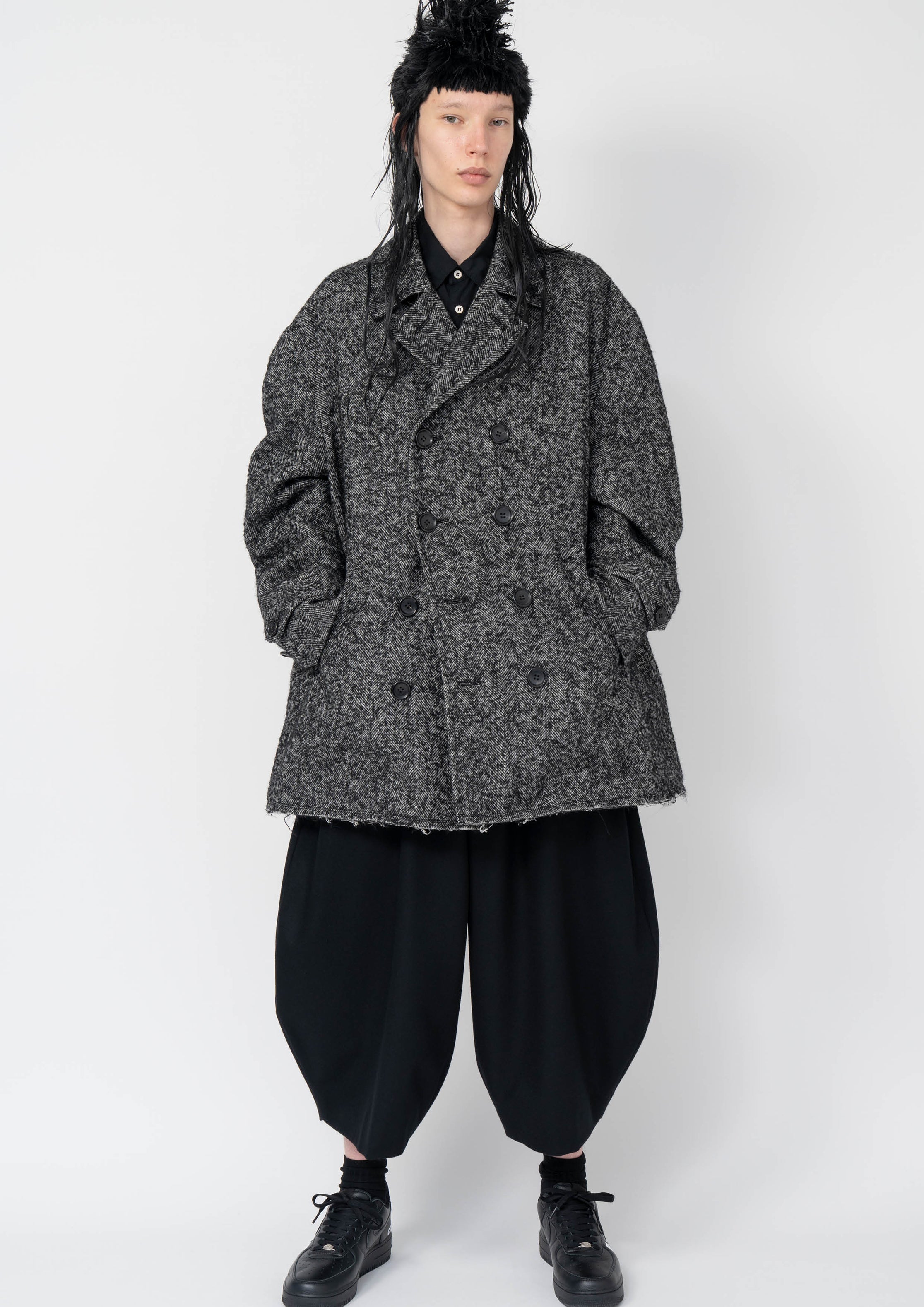 Fashion model wearing a Black Comme des Garçons AW25 outfit