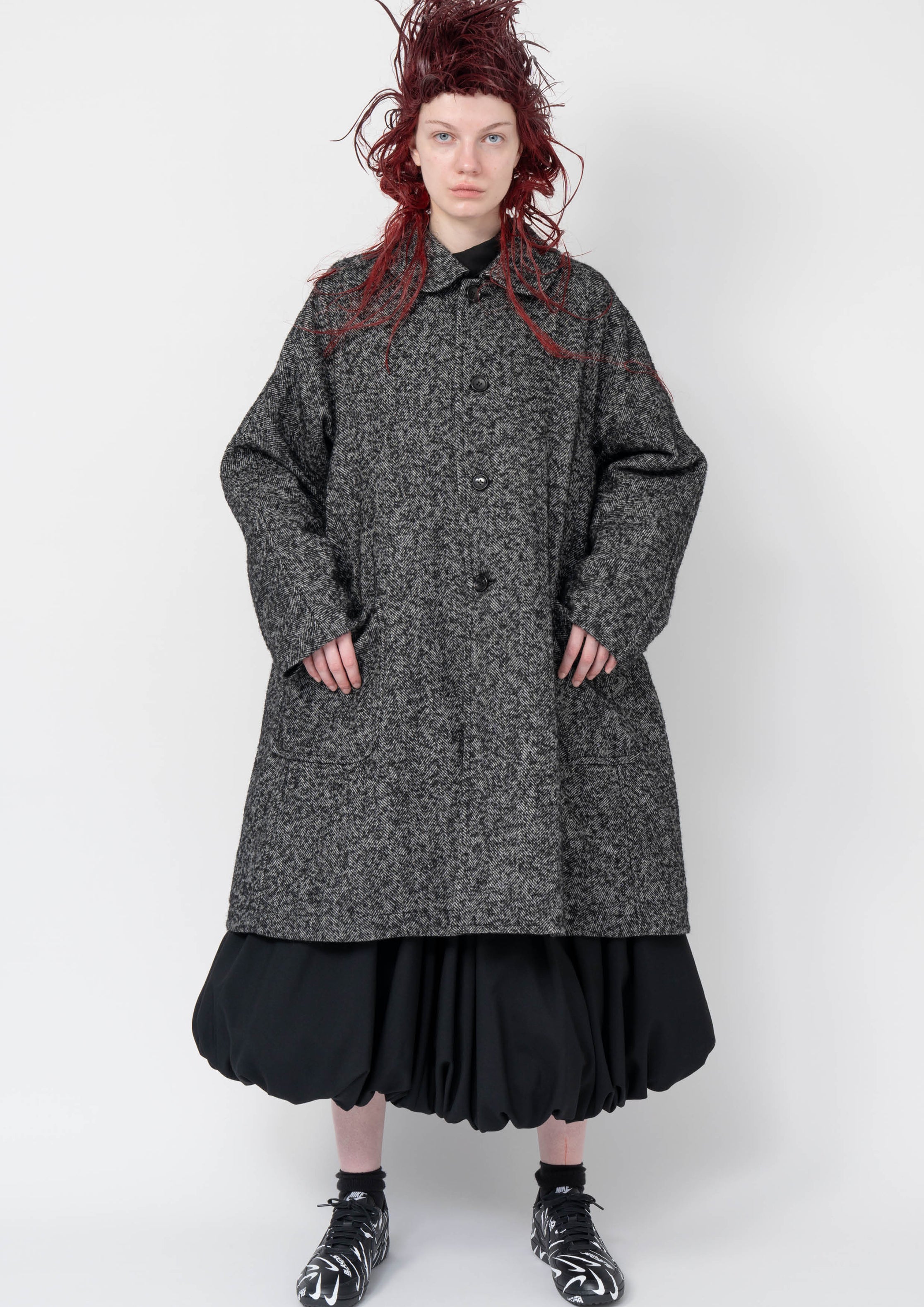 Fashion model wearing a Black Comme des Garçons AW25 outfit