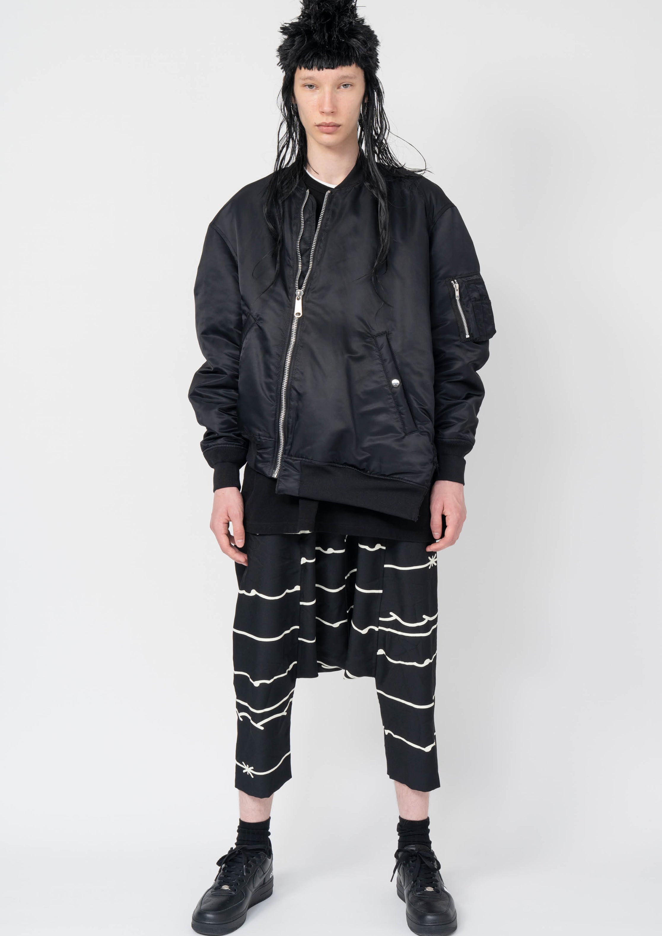 Fashion model wearing a Black Comme des Garçons AW25 outfit