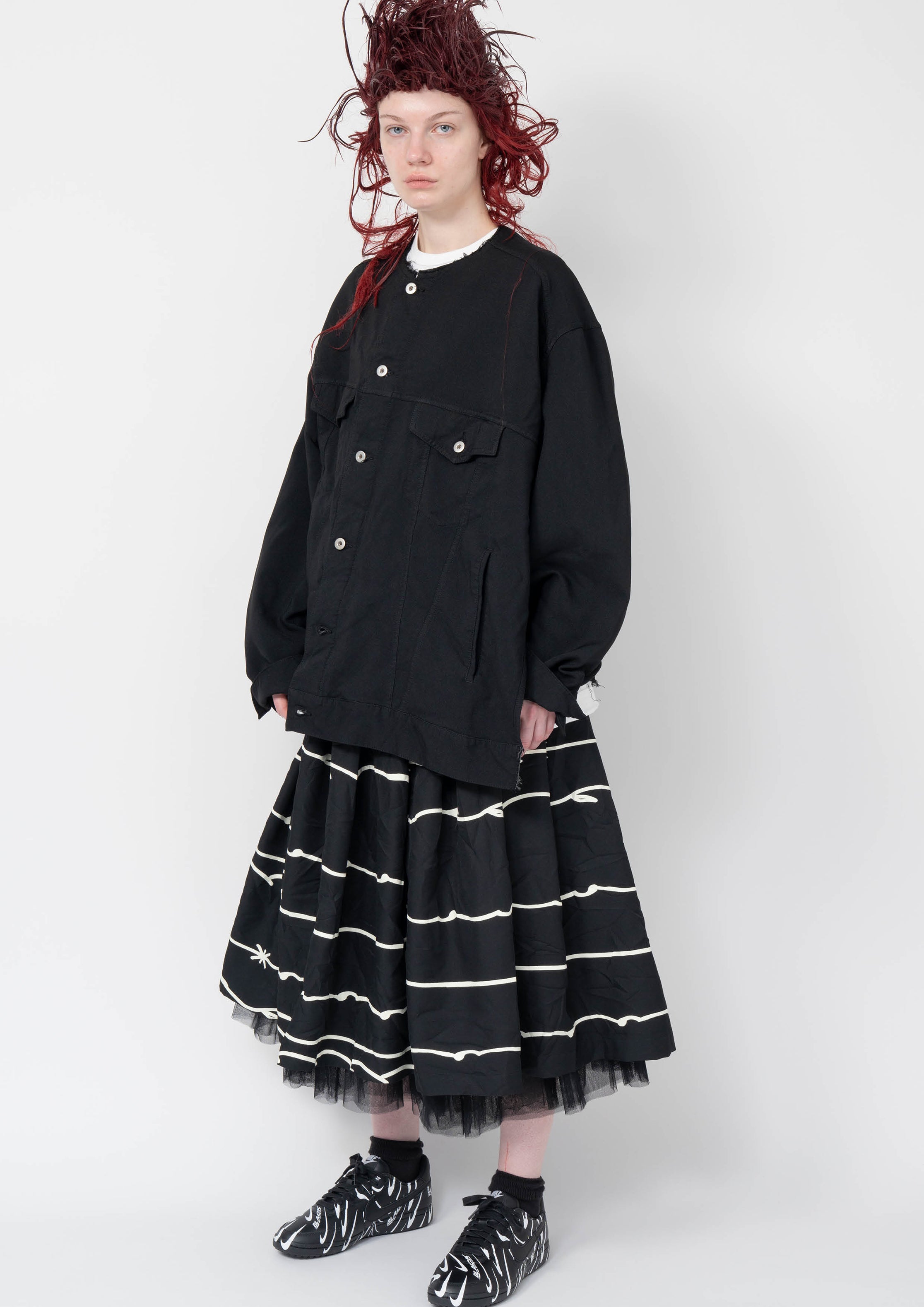 Fashion model wearing a Black Comme des Garçons AW25 outfit