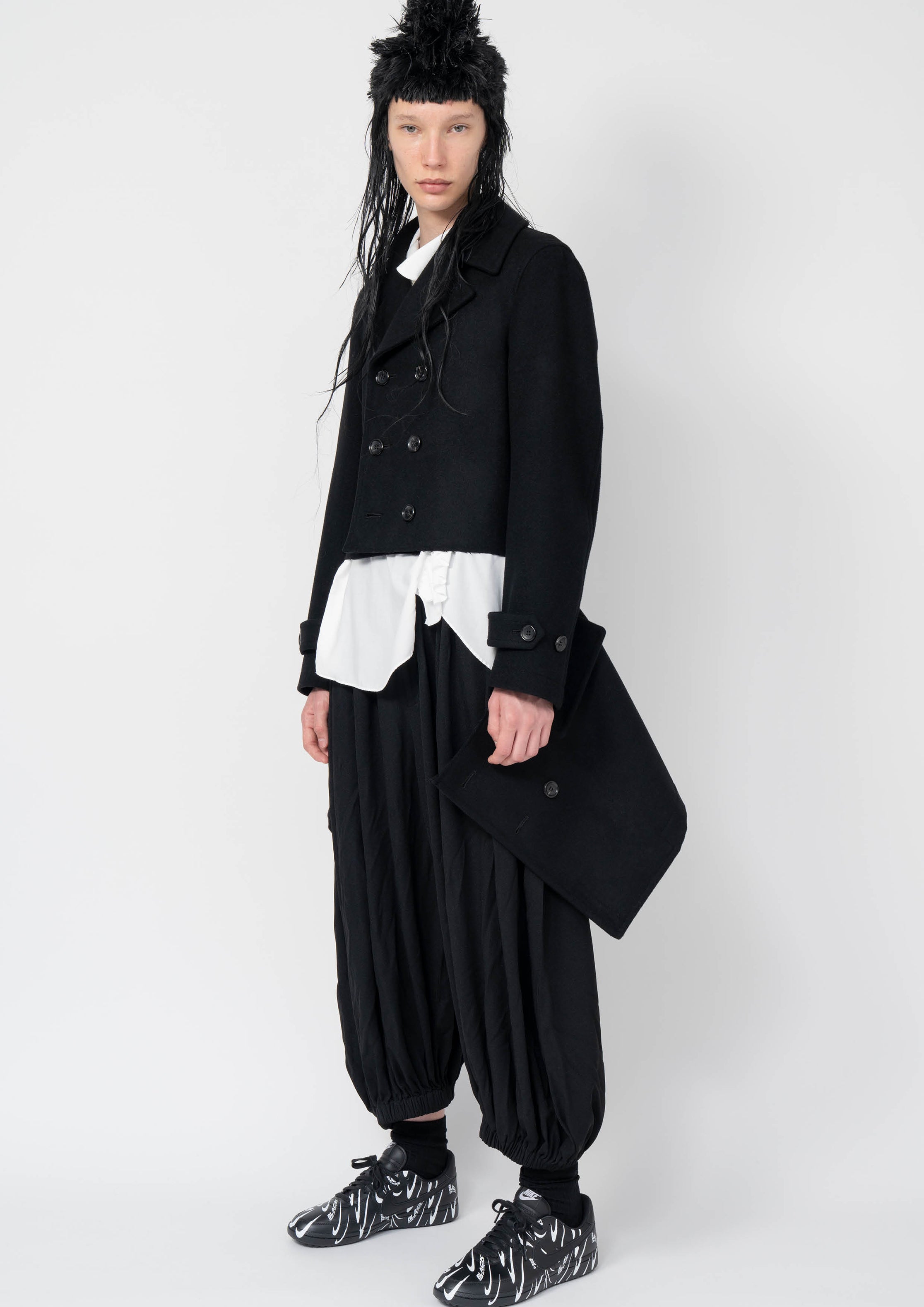 Fashion model wearing a Black Comme des Garçons AW25 outfit