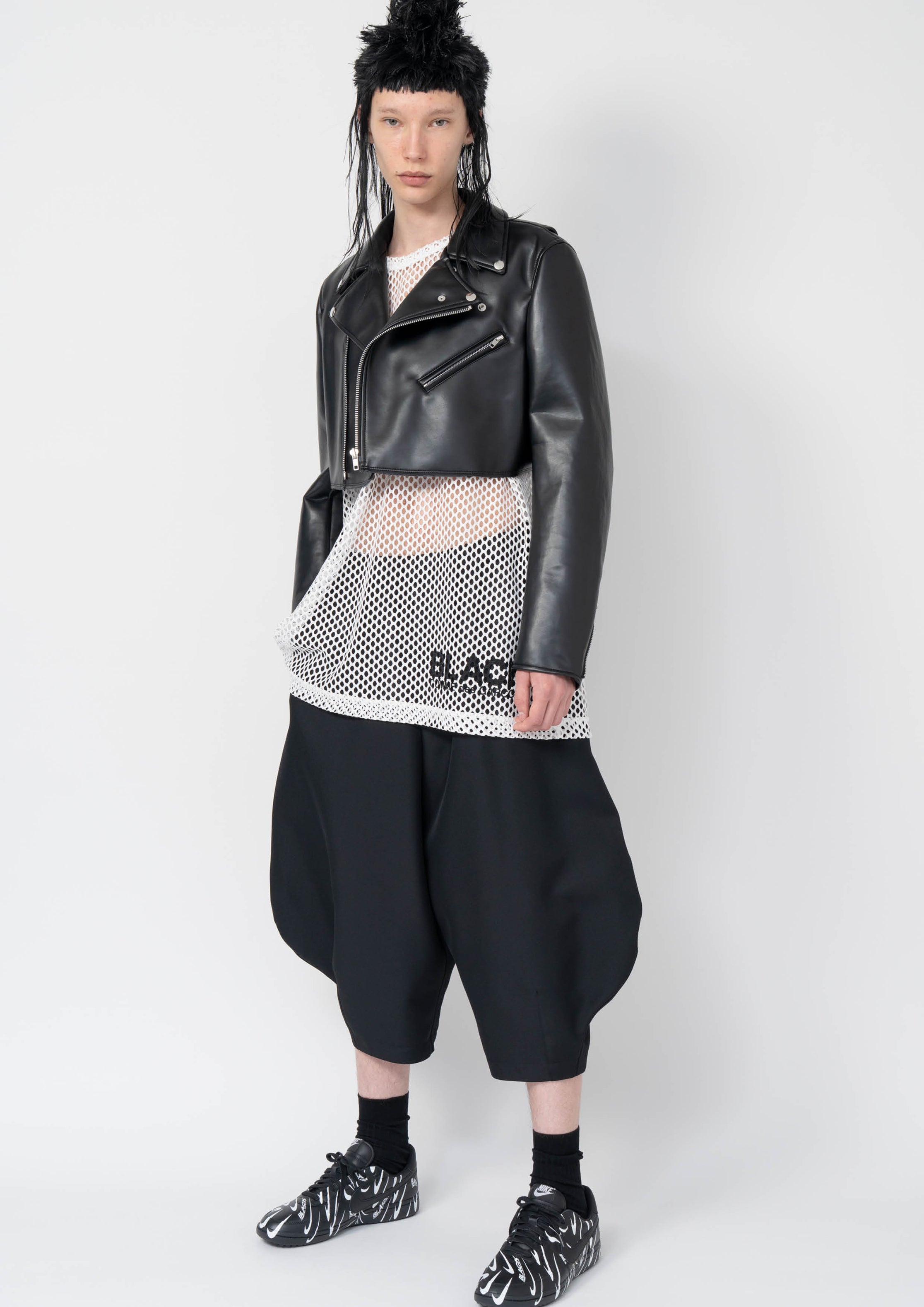 Fashion model wearing a Black Comme des Garçons AW25 outfit