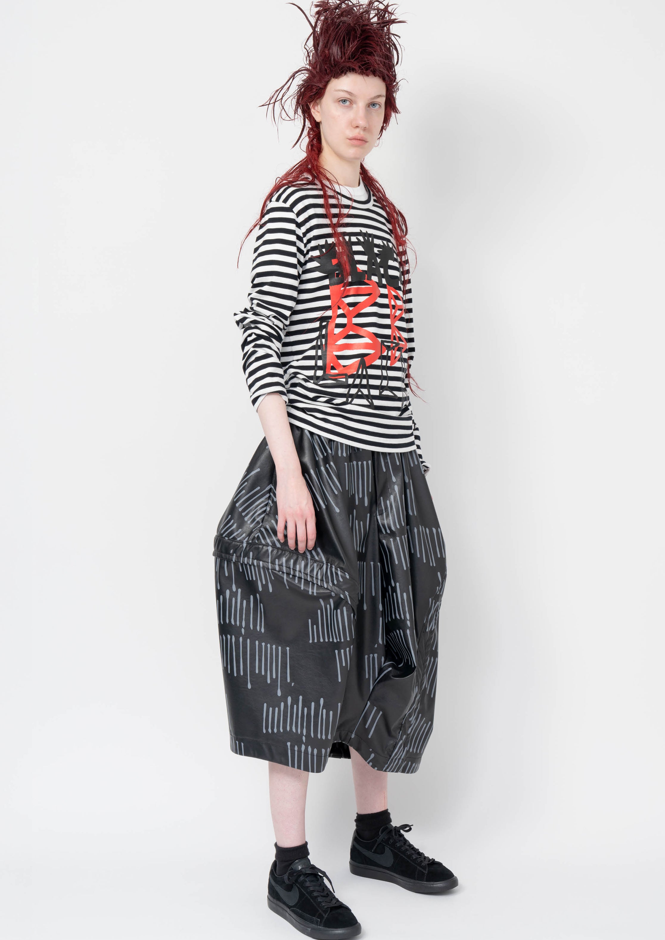 Fashion model wearing a Black Comme des Garçons AW25 outfit