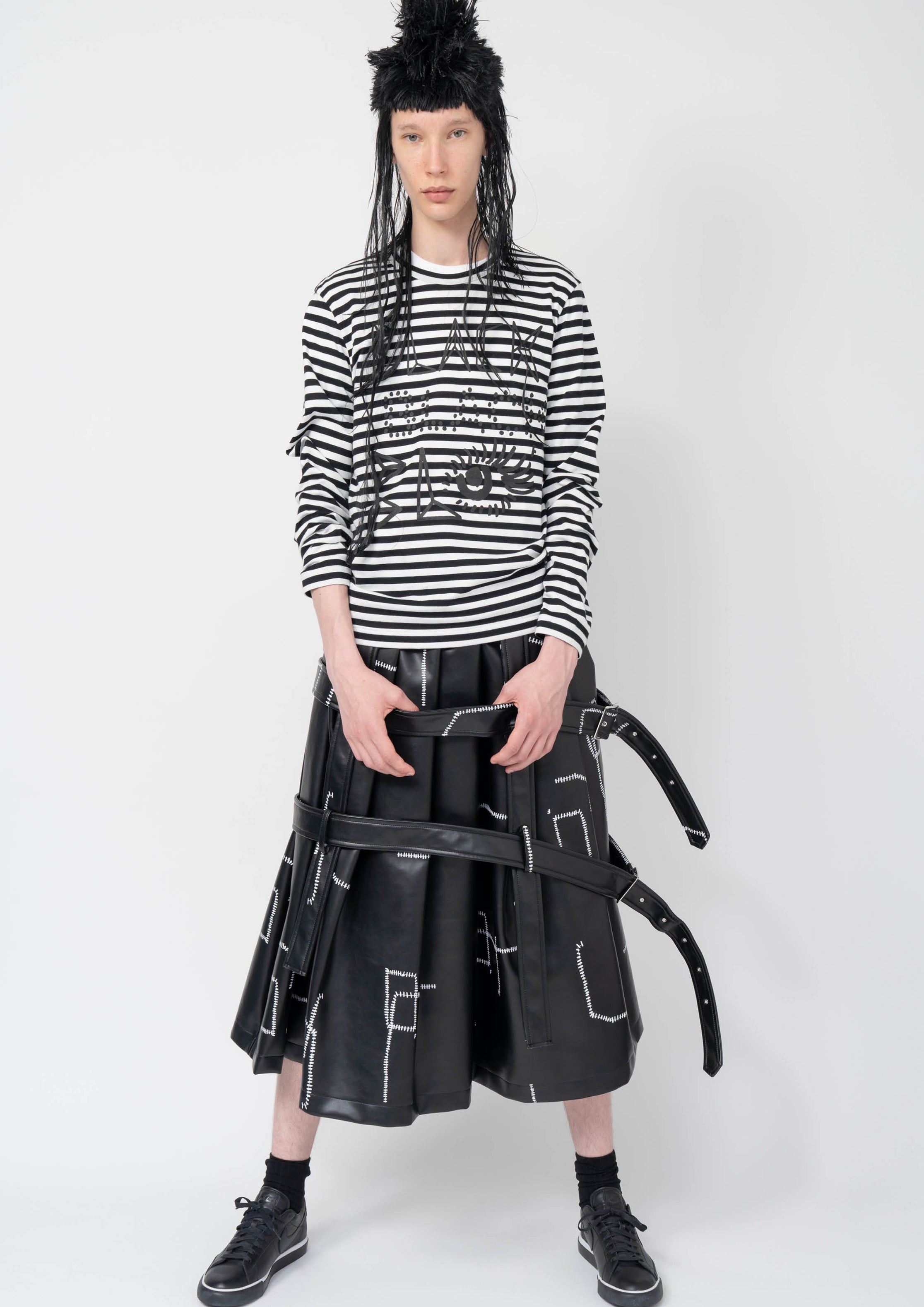 Fashion model wearing a Black Comme des Garçons AW25 outfit