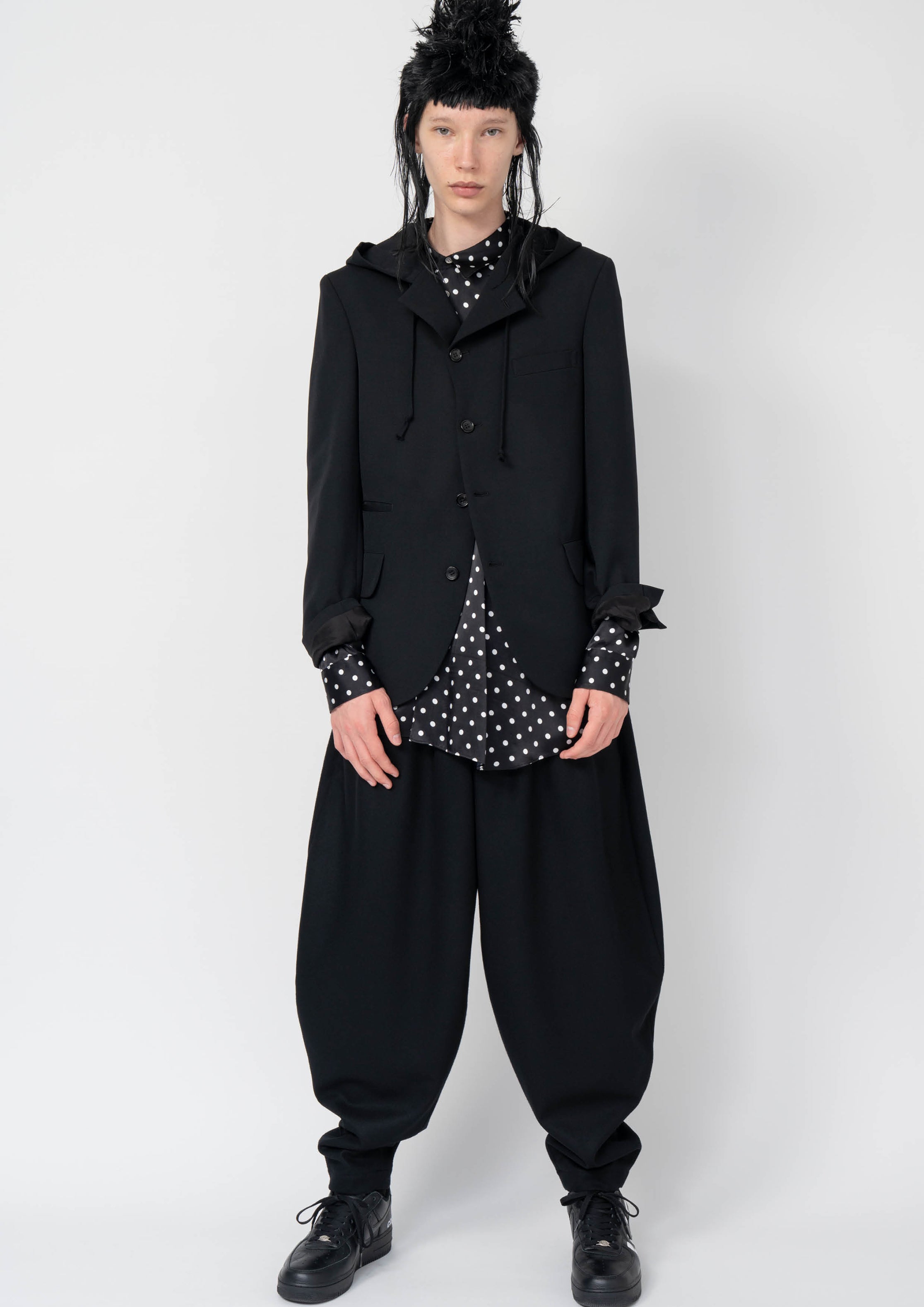 Fashion model wearing a Black Comme des Garçons AW25 outfit