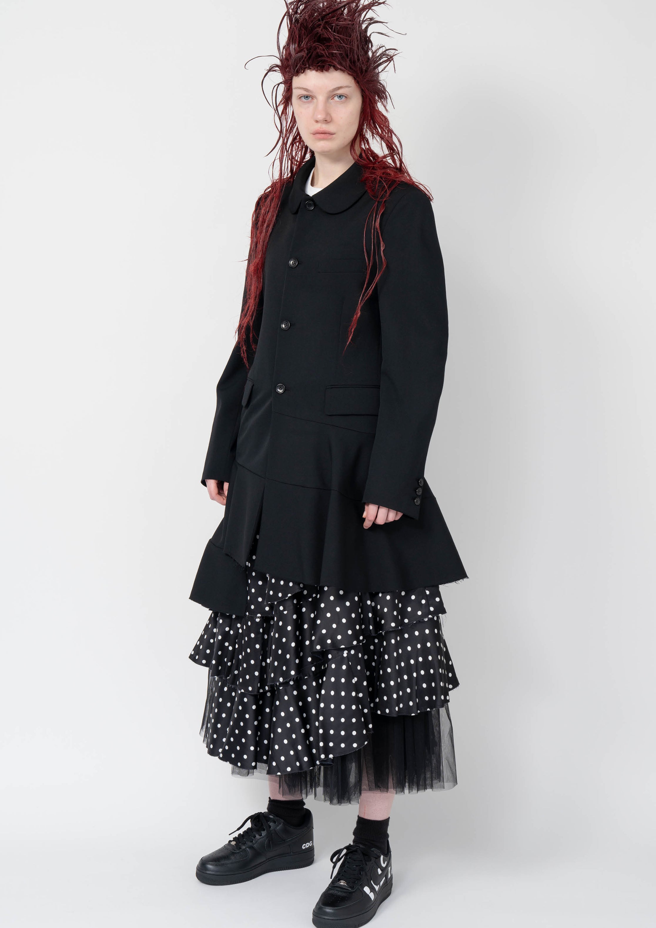 Fashion model wearing a Black Comme des Garçons AW25 outfit