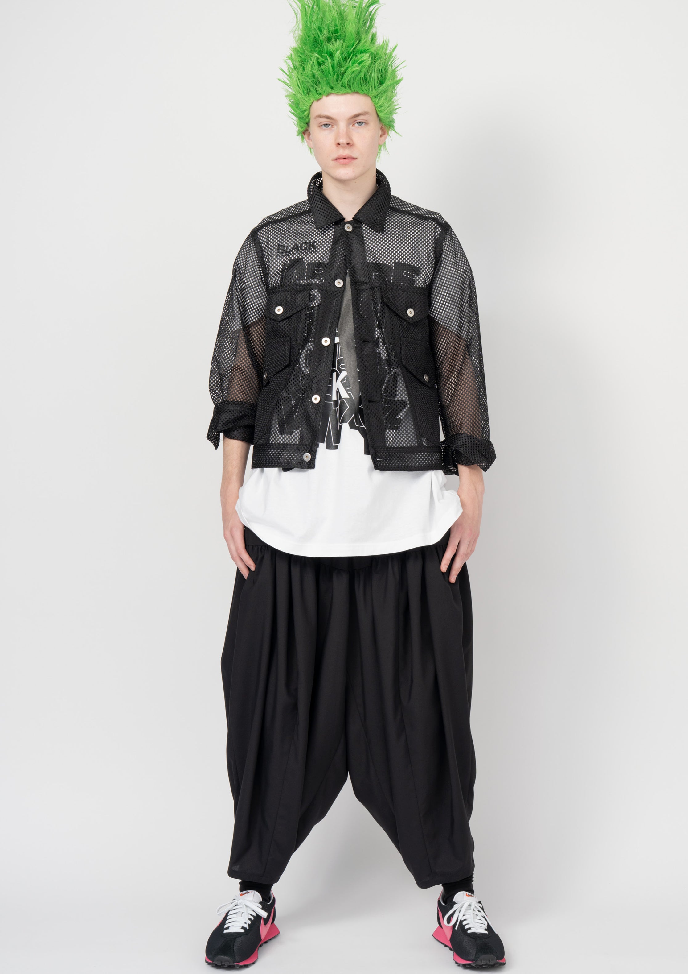 Fashion model wearing a Black Comme des Garçons SS26 outfit