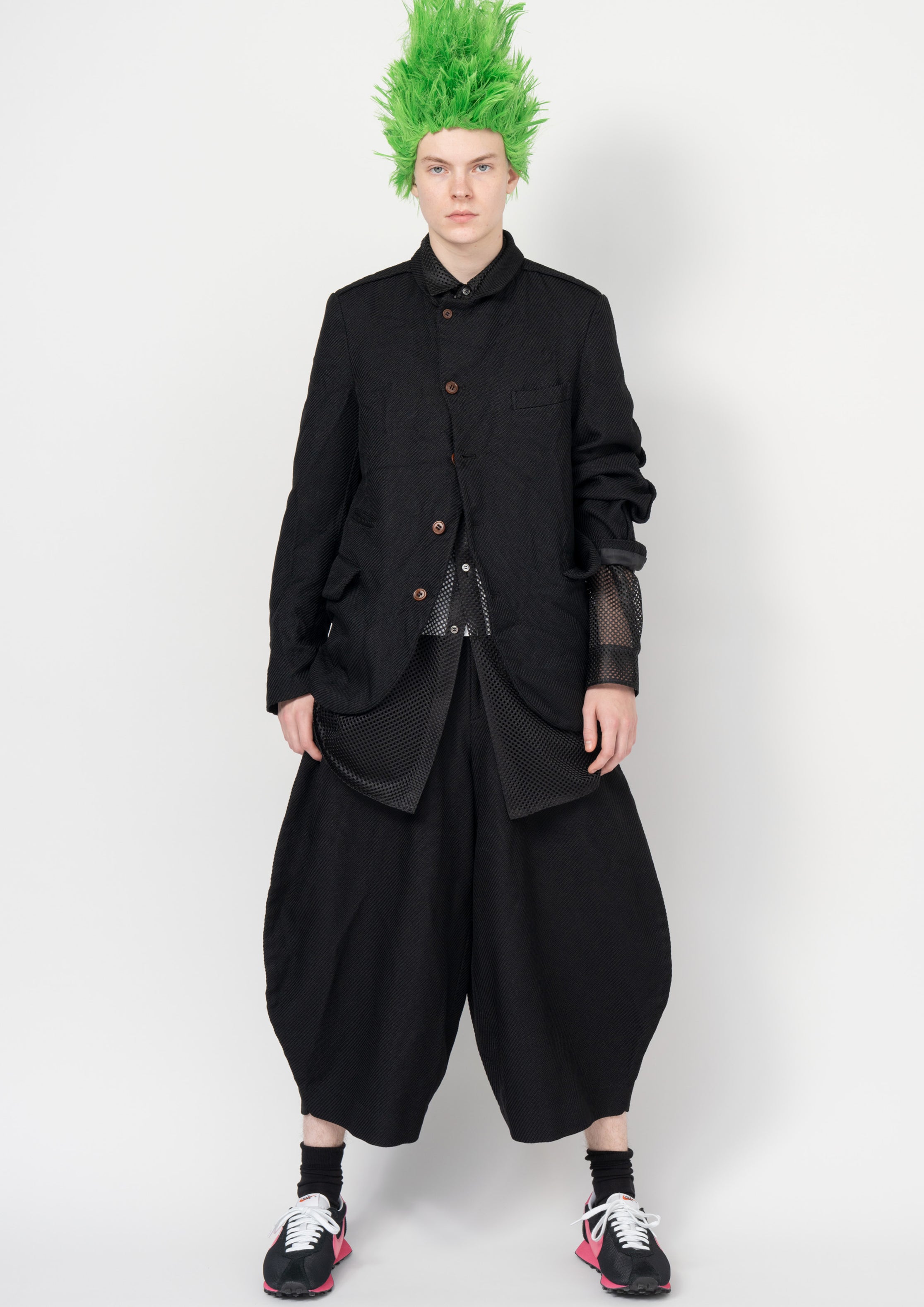 Fashion model wearing a Black Comme des Garçons SS26 outfit