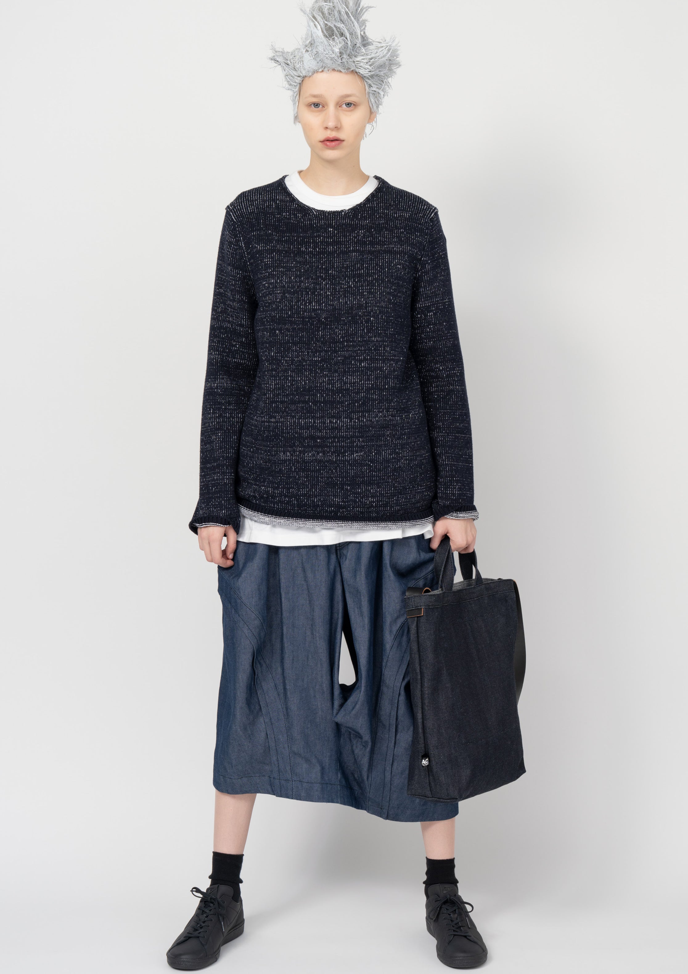 Fashion model wearing a Black Comme des Garçons SS26 outfit