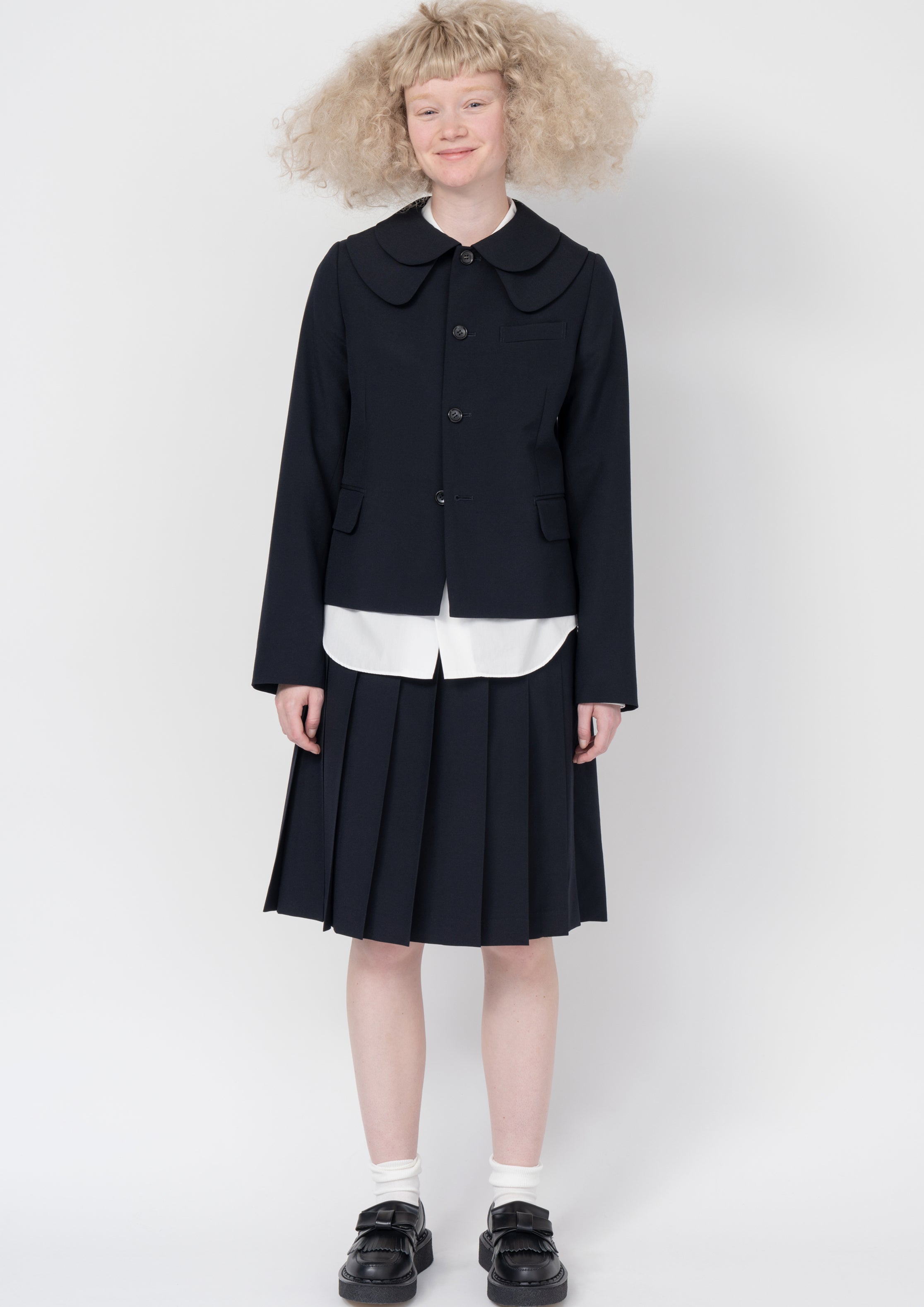 Fashion model wearing a Comme des Garçons SS26 outfit