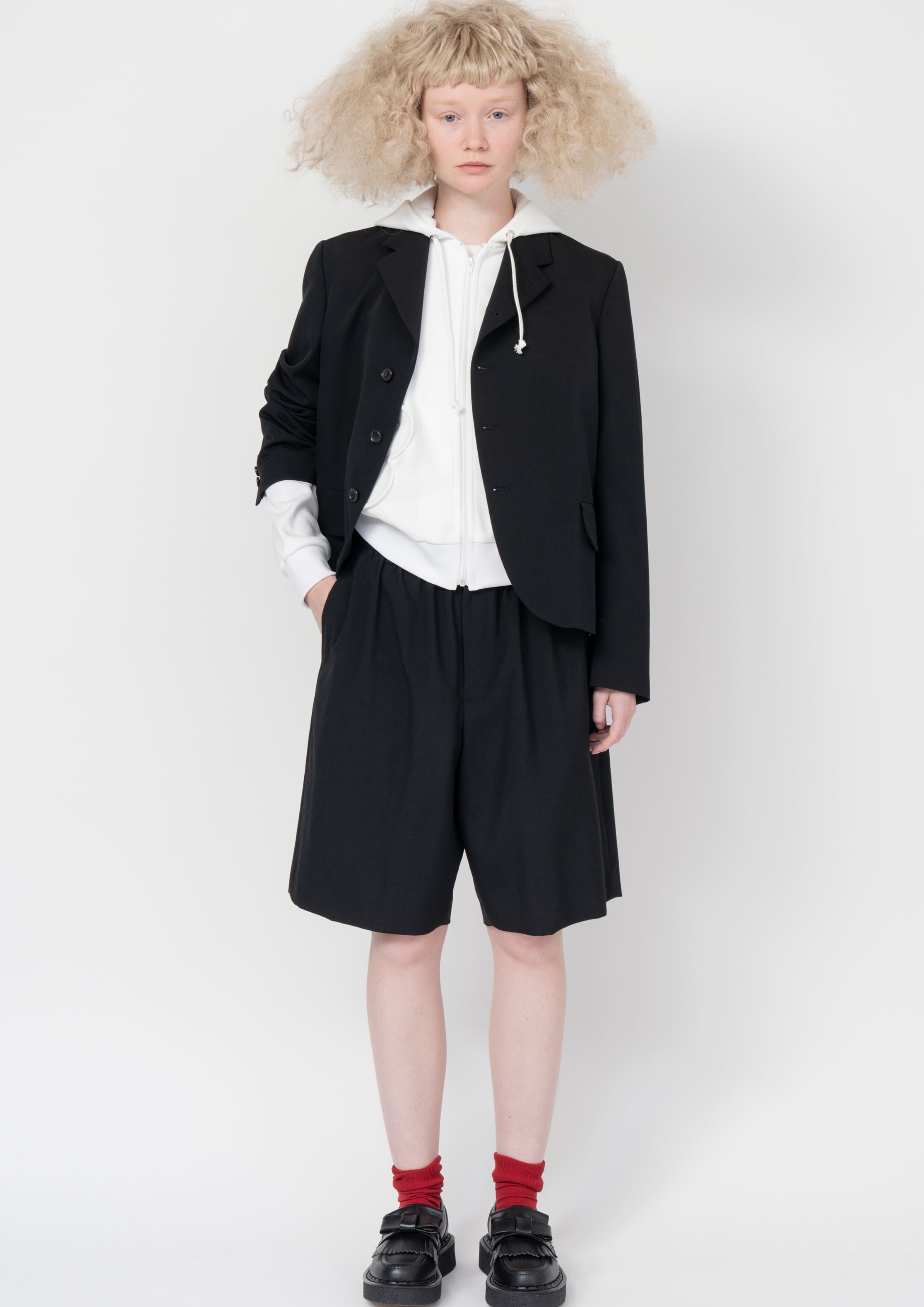 Fashion model wearing a Comme des Garçons SS26 outfit