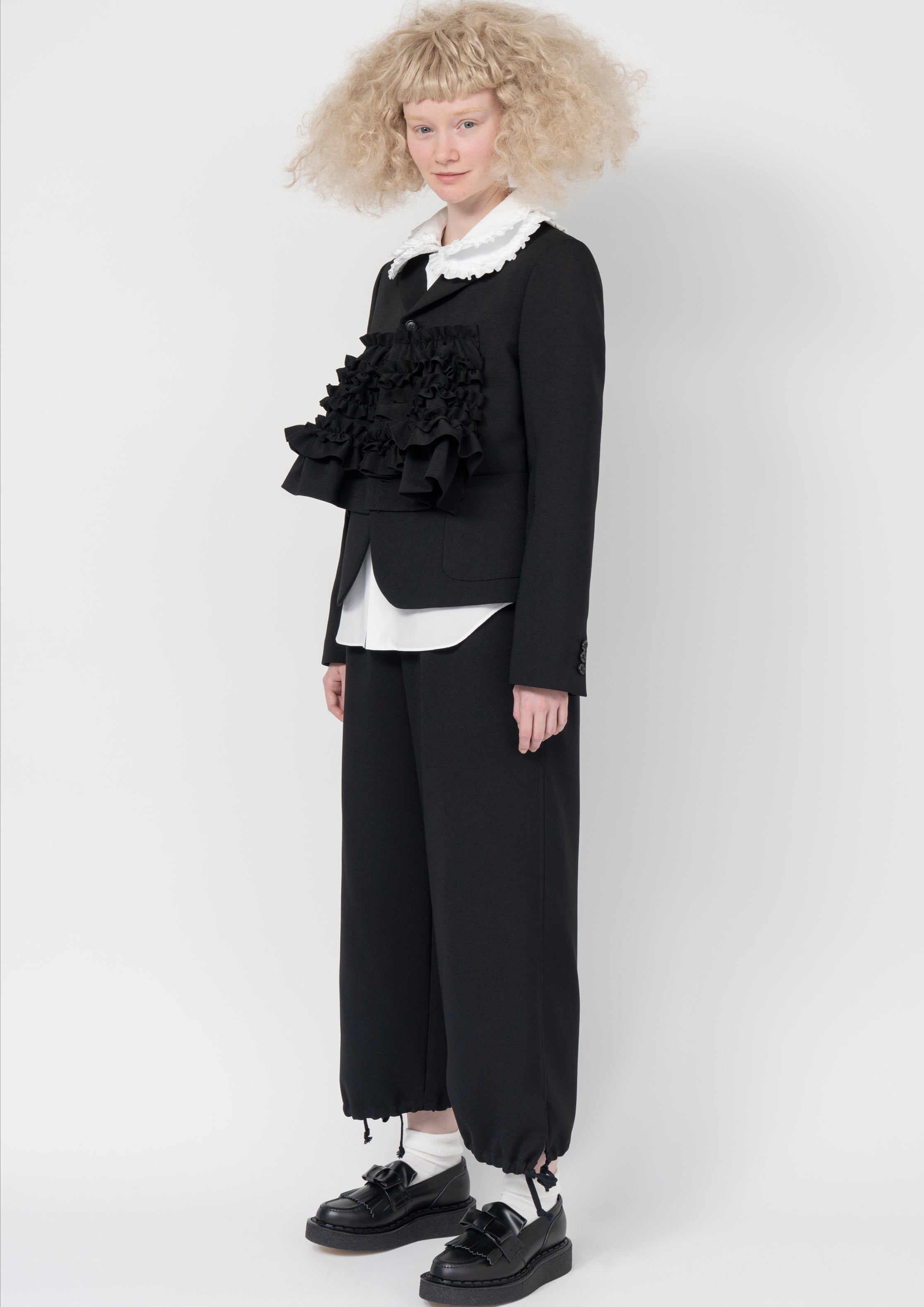 Fashion model wearing a Comme des Garçons SS26 outfit