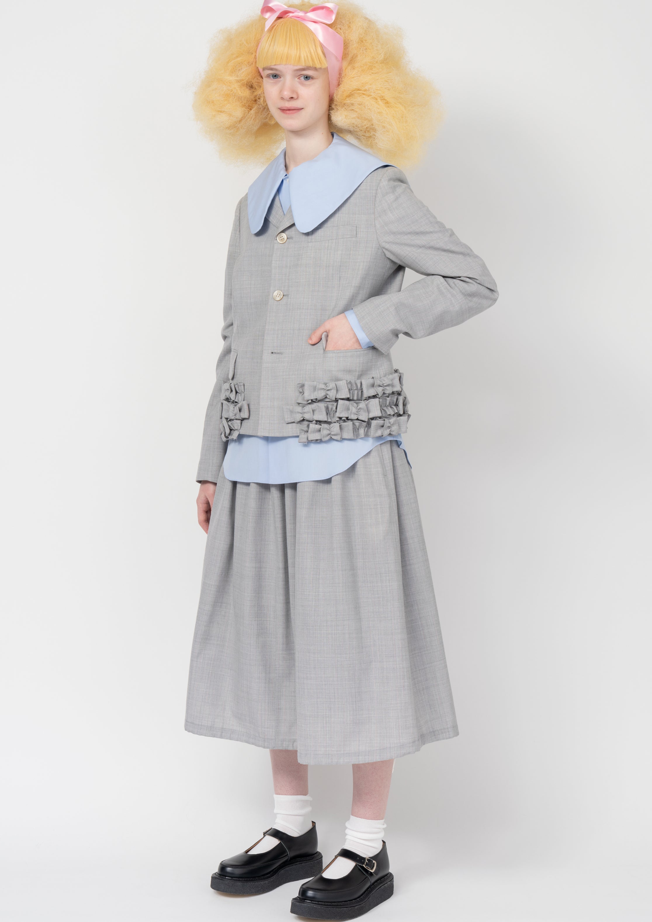 Fashion model wearing a Comme des Garçons SS26 outfit