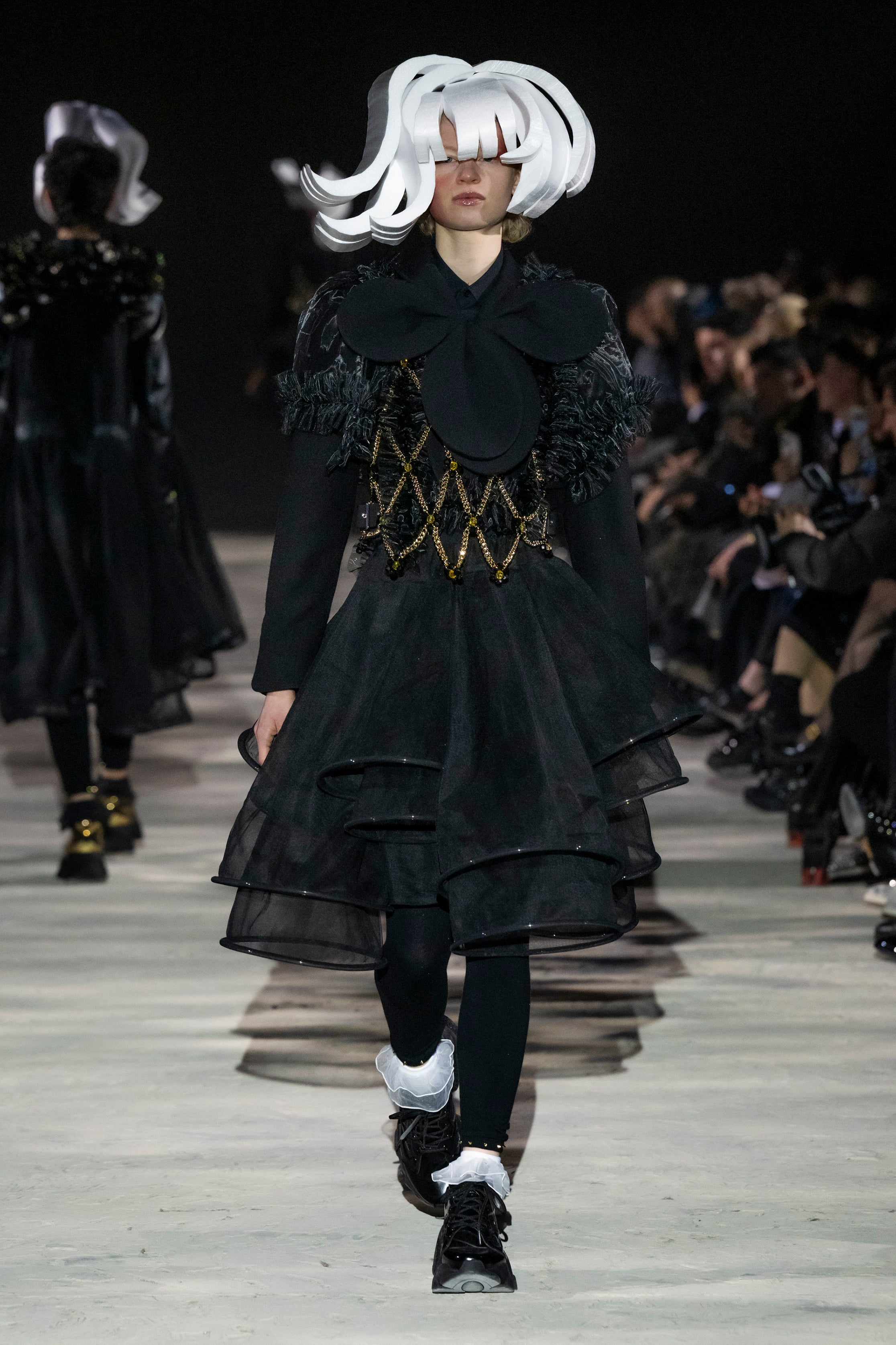 Fashion model wearing a noir kei ninomiya AW25 outfit