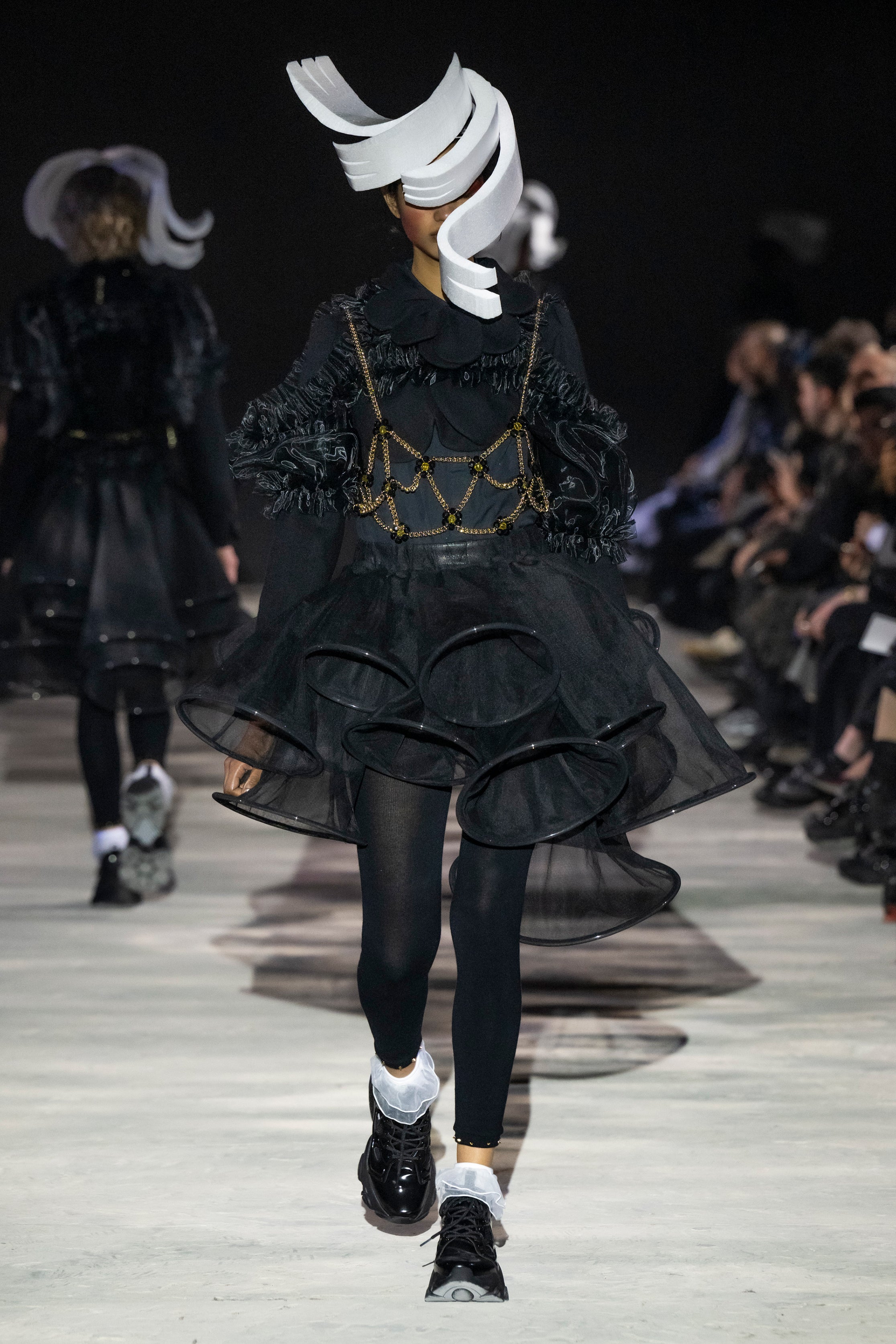 Fashion model wearing a noir kei ninomiya AW25 outfit