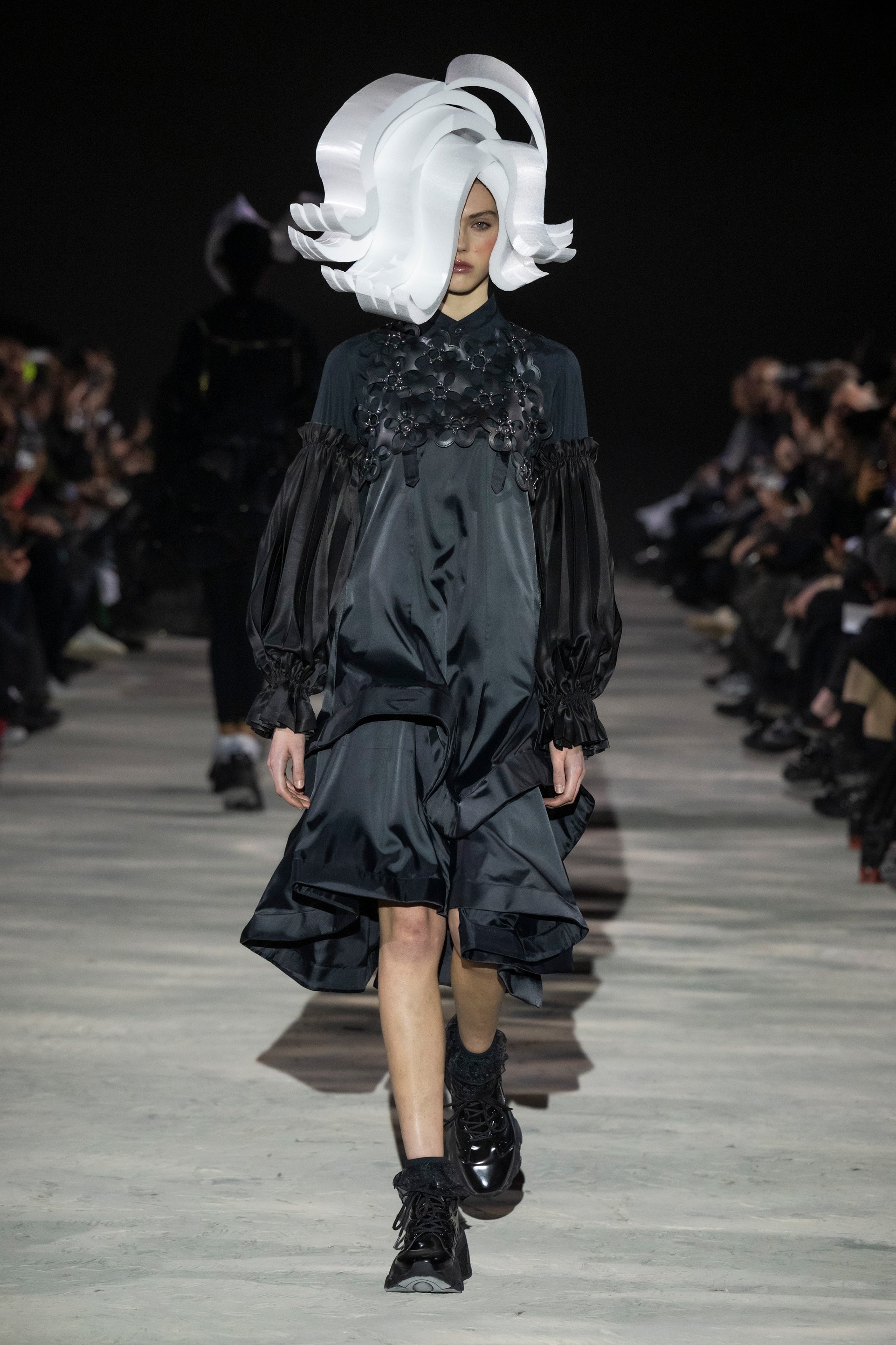 Fashion model wearing a noir kei ninomiya AW25 outfit