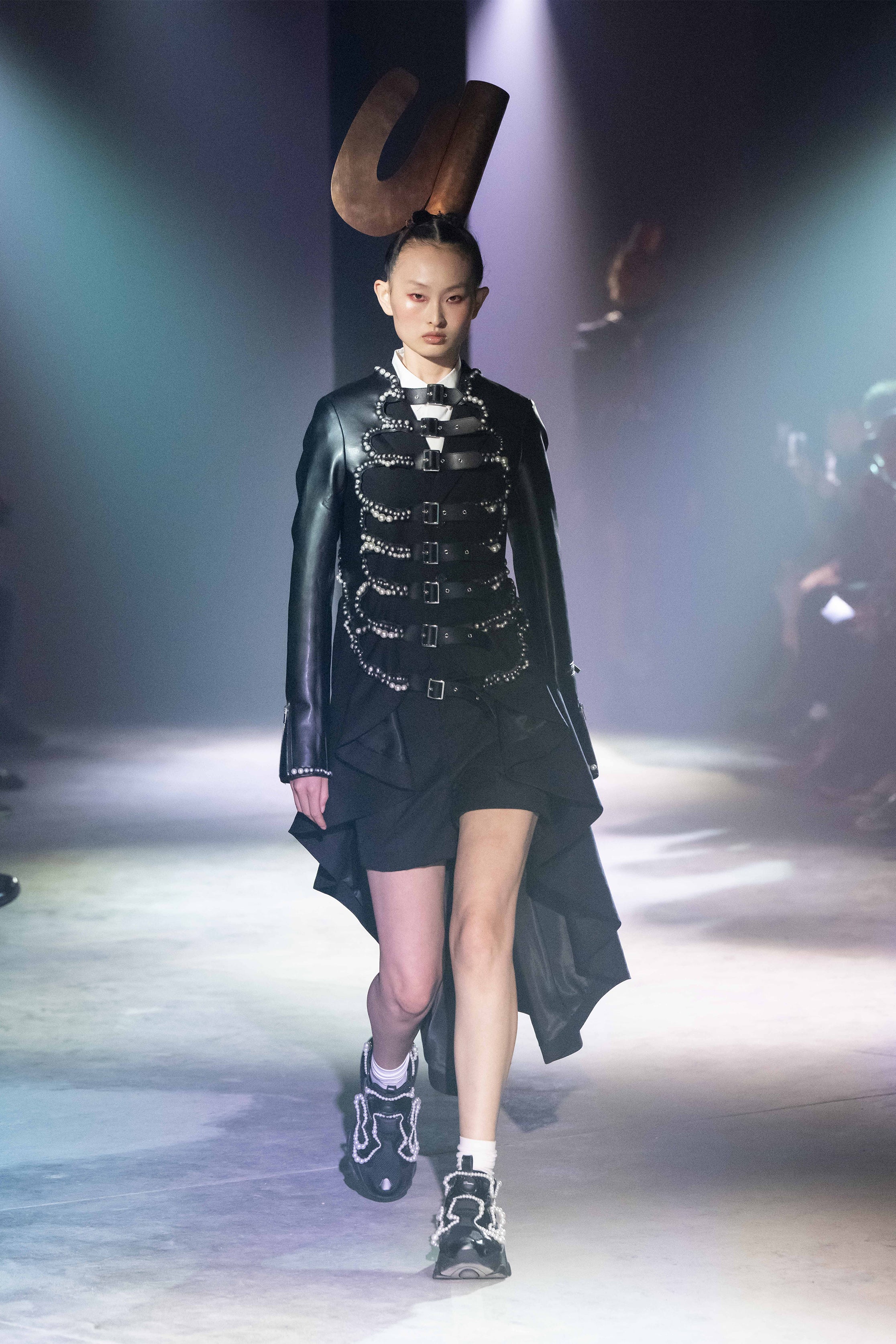 Fashion model wearing a NOIR KEI NINOMIYA SS25 outfit