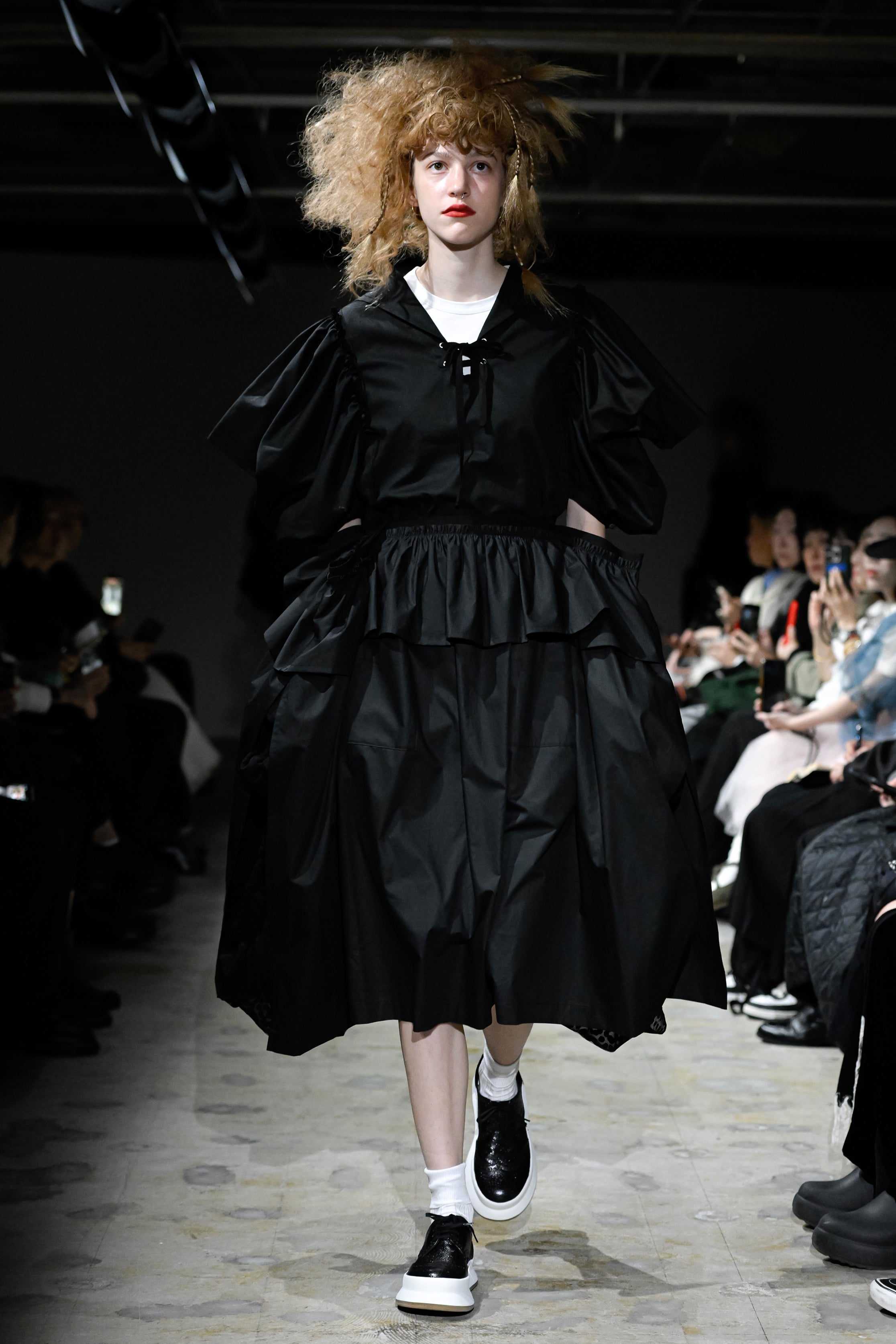 Fashion model wearing a tao SS26 outfit